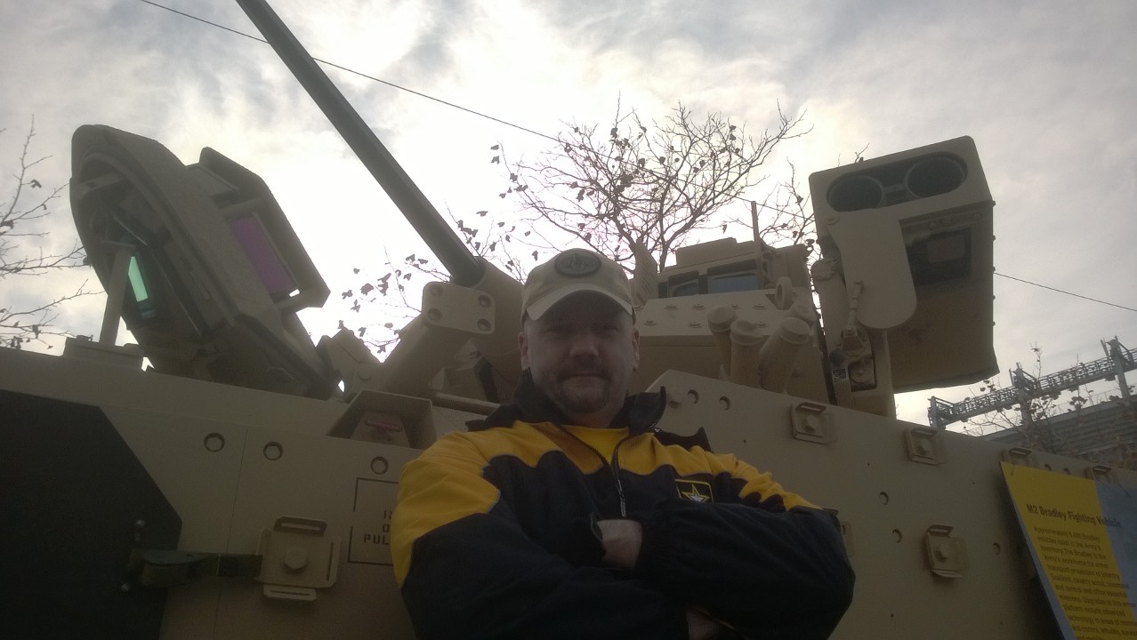 Hoeppel in front of a Bradley armored fighting vehicle